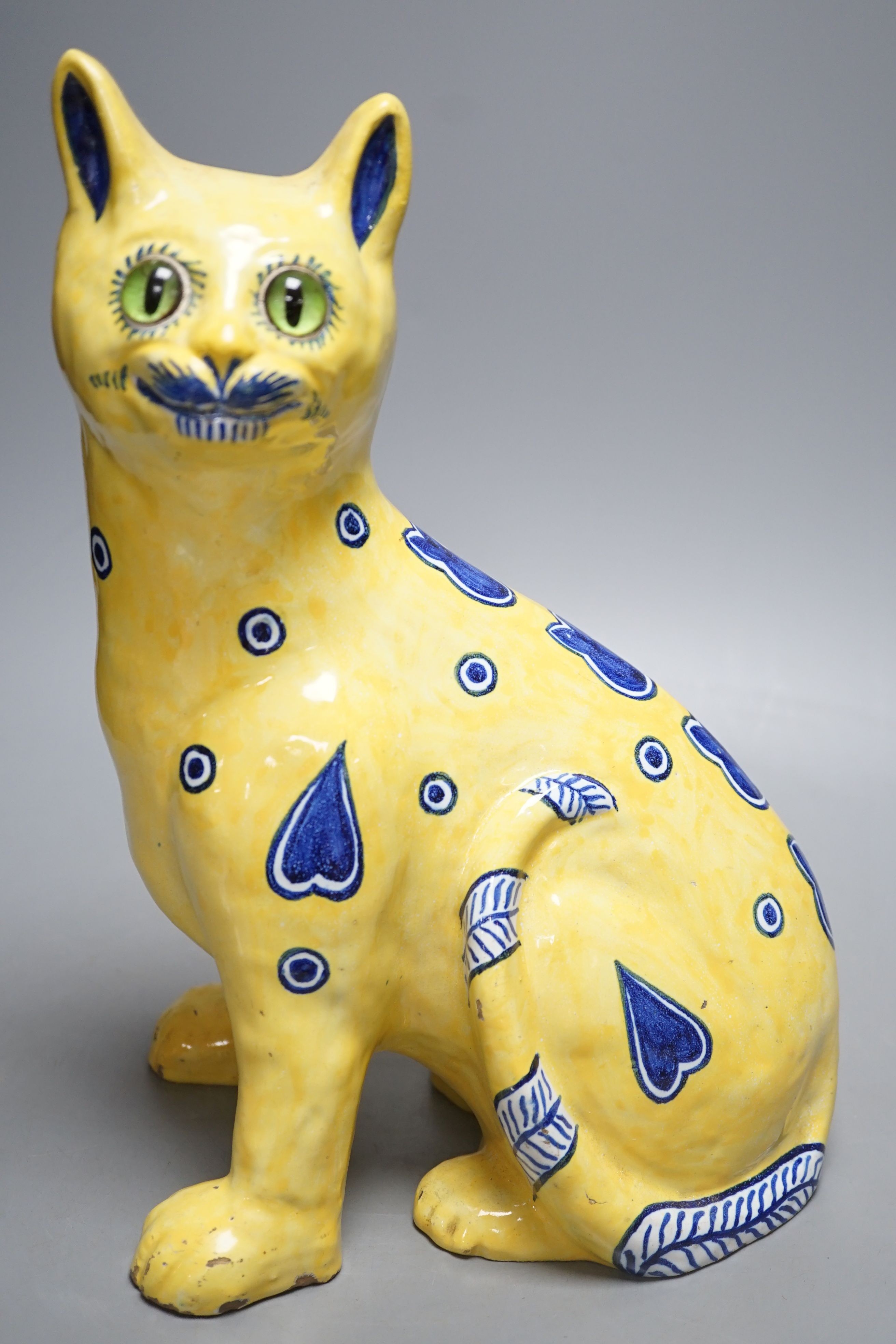 A Mosanic Galle style seated yellow and blue faience cat - 31cm tall
